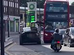 Tesla Model X drives off with one of its 'falcon wing' doors open and smashes into a London bus