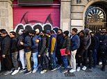 Huge numbers of migrants queue along the street to collect paperwork after socialist Spain announced it would grant legal status to 500,000 - sparking row between PM and Elon Musk over rigging elections